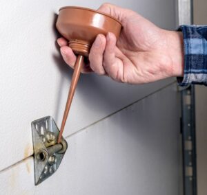 how to lubricate garage door hinges